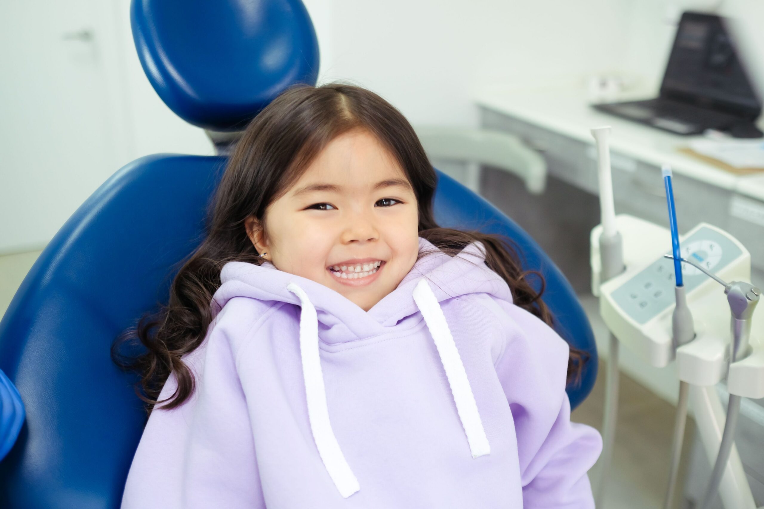 Young girl in chair at dentist office